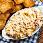 Slow Cooker Reuben Dip in a serving dish with toasted bread slices.