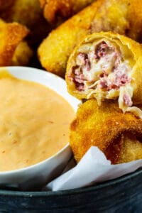 Reuben Egg Rolls with bowl full of Thousand Island Dressing.