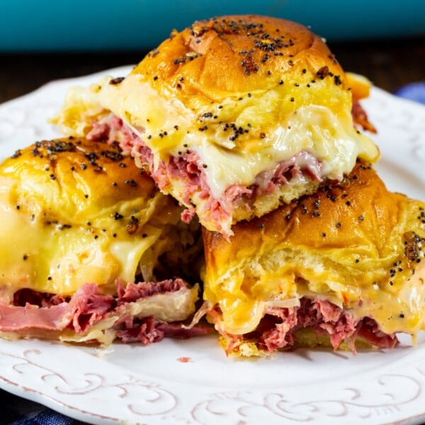 Baked Reuben Sliders piled on a plate.