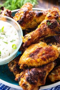 Roasted Ranch Wings on a plate with bowl of ranch dressing.