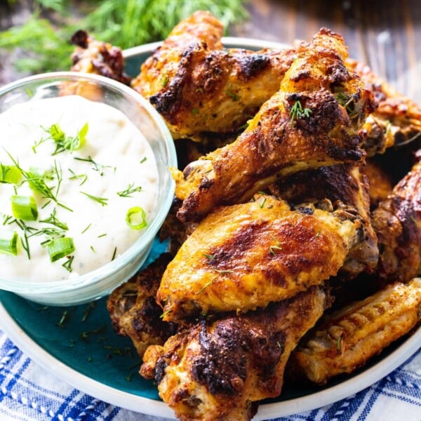 Roasted Ranch Wings on a plate with bowl of ranch dressing.