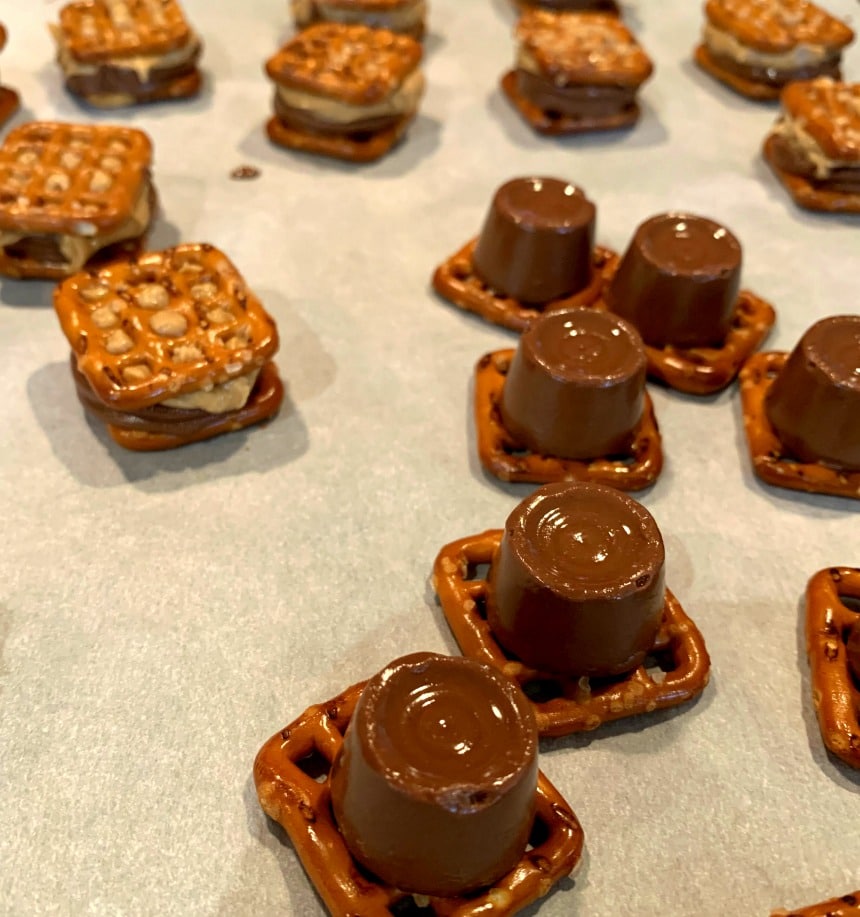 Rolo candies placed on top of pretzels.