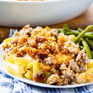 Sandy's Chicken (Chicken with Stuffing and Cheese) over egg noodles with a side of green beans.