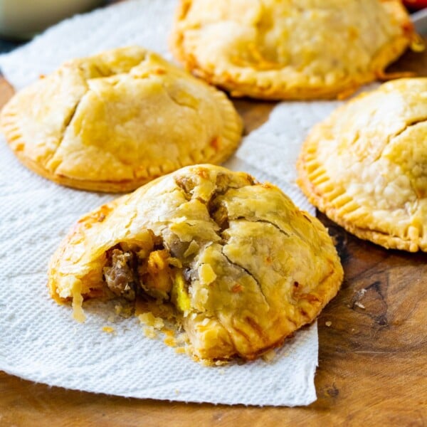 Hand Pies on a wooden board with bite out of one.