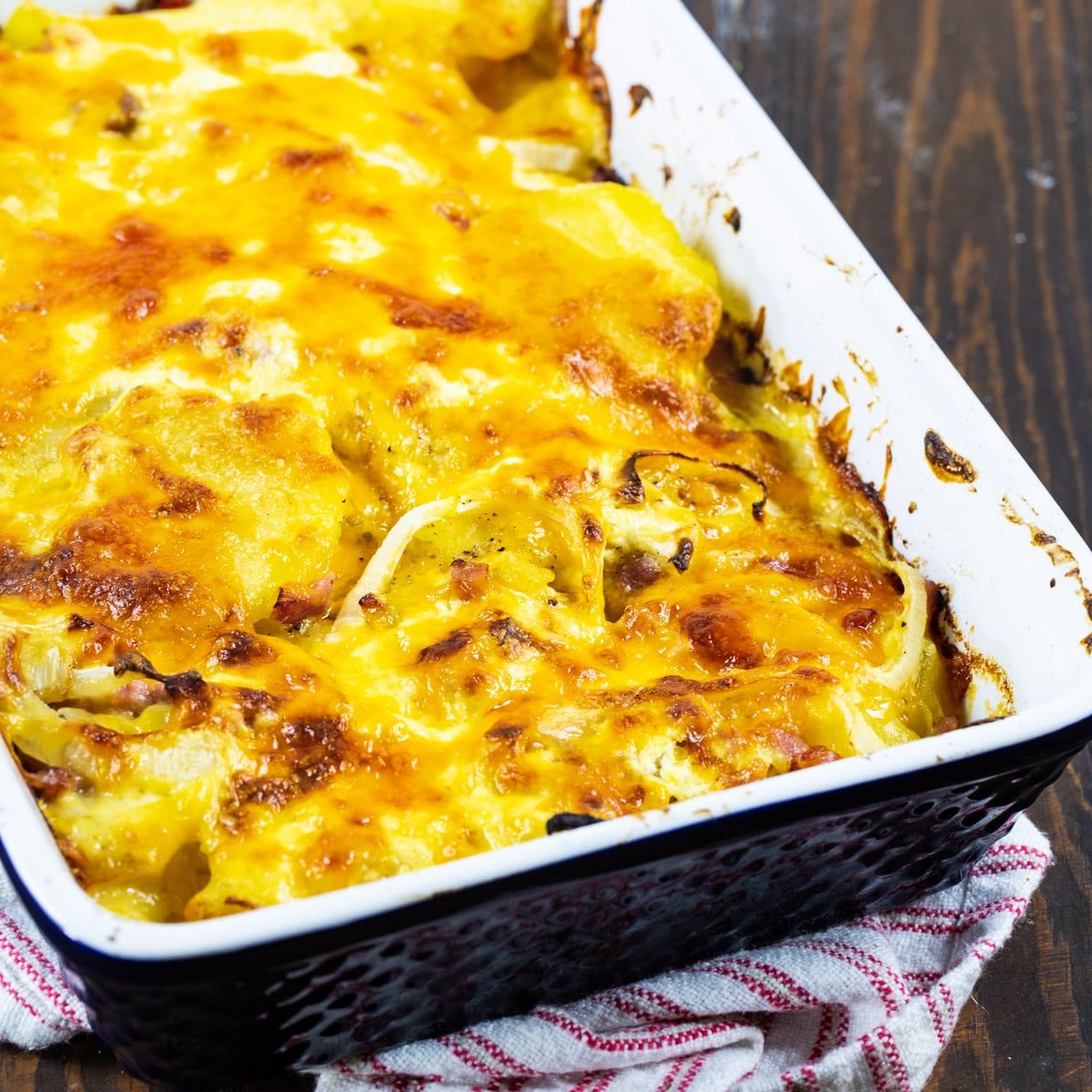 Scalloped Potatoes with Ham in a blue casserole dish.