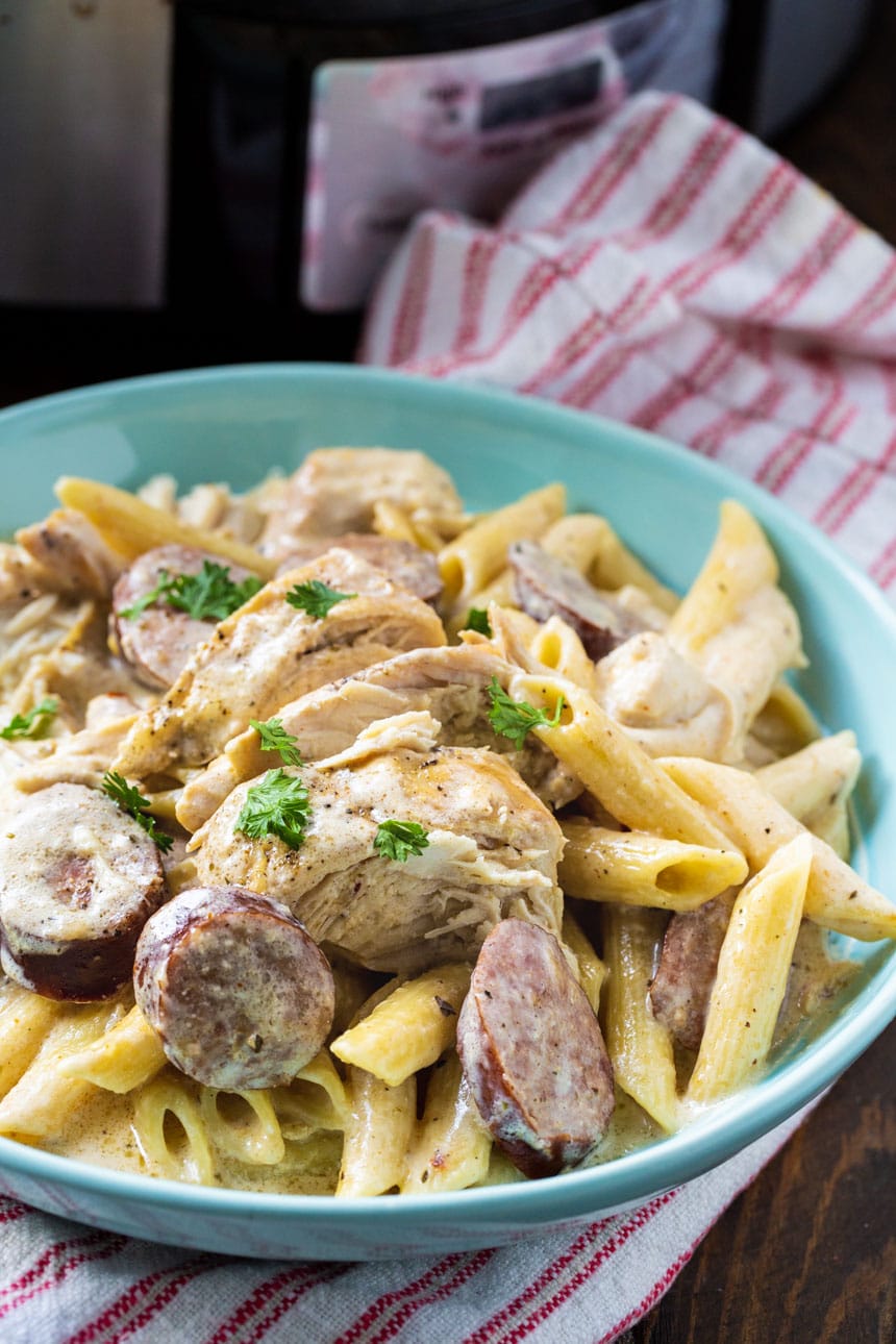 Alfredo Pasta with Chicken and Sausage in a blue bowl.