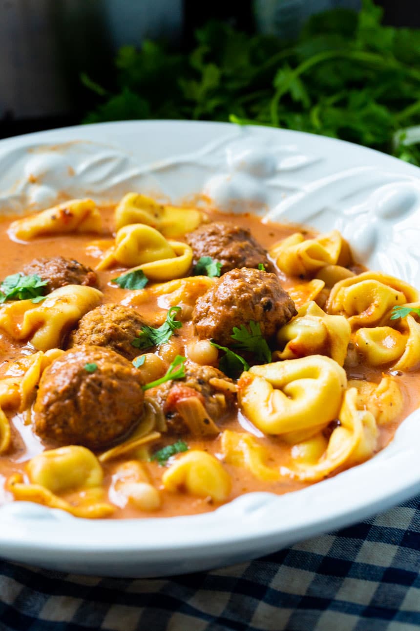 Slow Cooker Meatball and Tortellini Soup in a white bowl.