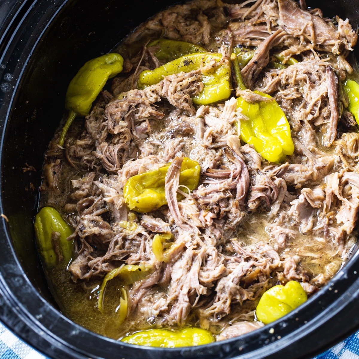 Slow Cooker Mississippi Pulled Pork with pepperoncini peppers in a crock pot.