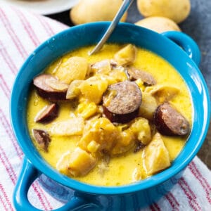 Chowder with Sausage and Potatoes in a blue bowl.