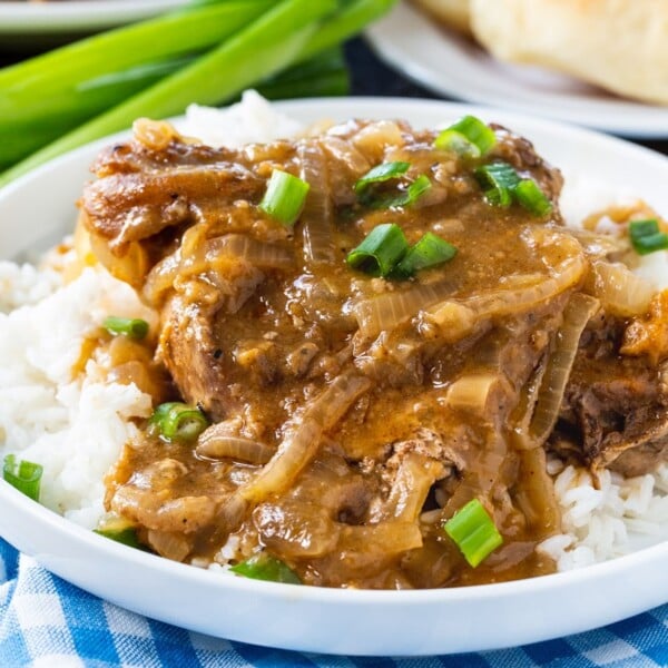 Slow Cooker Smothered Pork Chops served over white rice