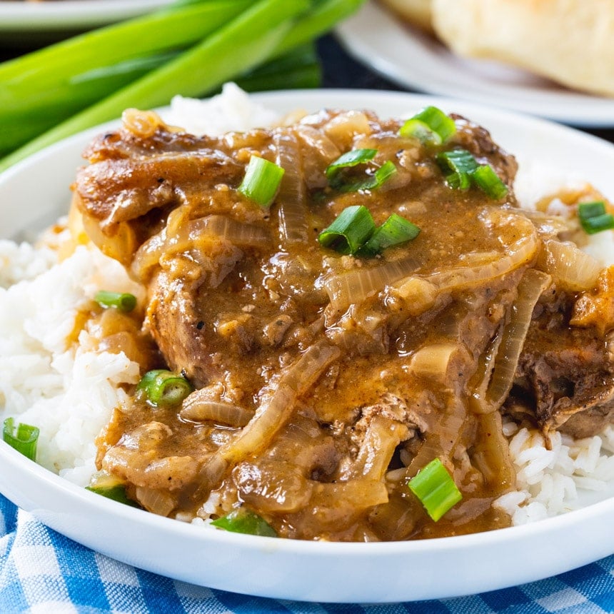 Slow Cooker Smothered Pork Chops served over white rice