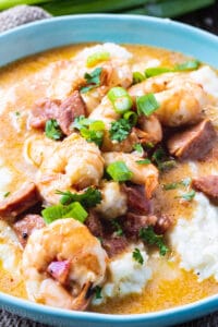 Smothered Shrimp and Parmesan Grits in a blue bowl.