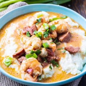 Smothered Shrimp and Parmesan Grits in a blue bowl.