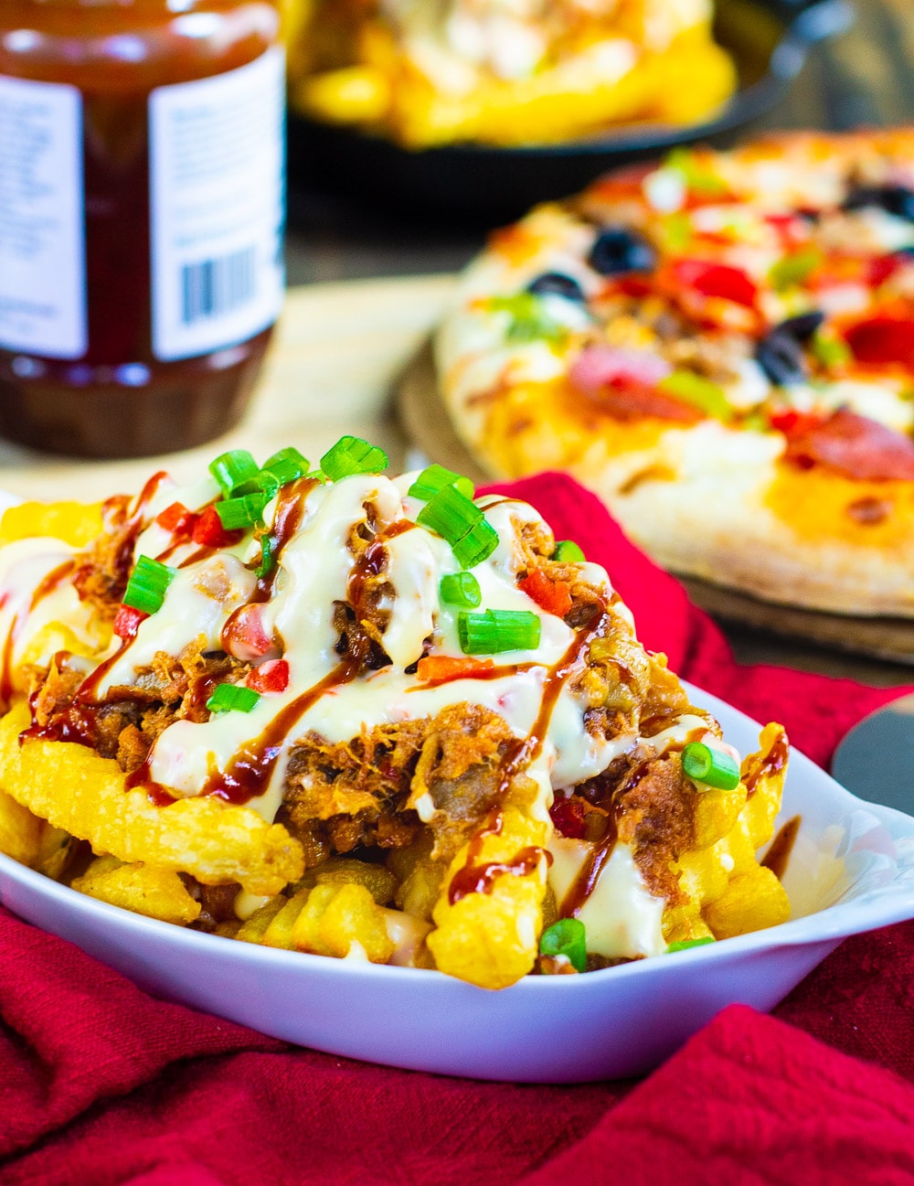 Pile of fries topped with BBQ pork and pimento cheese sauce.