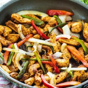 Chicken, bell peppers, and onion in large skillet.