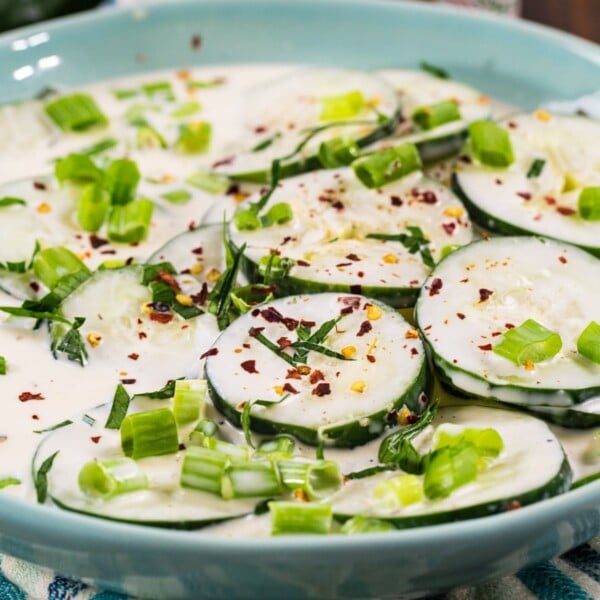 Creamy Spicy Cucumbers in a blue bowl.