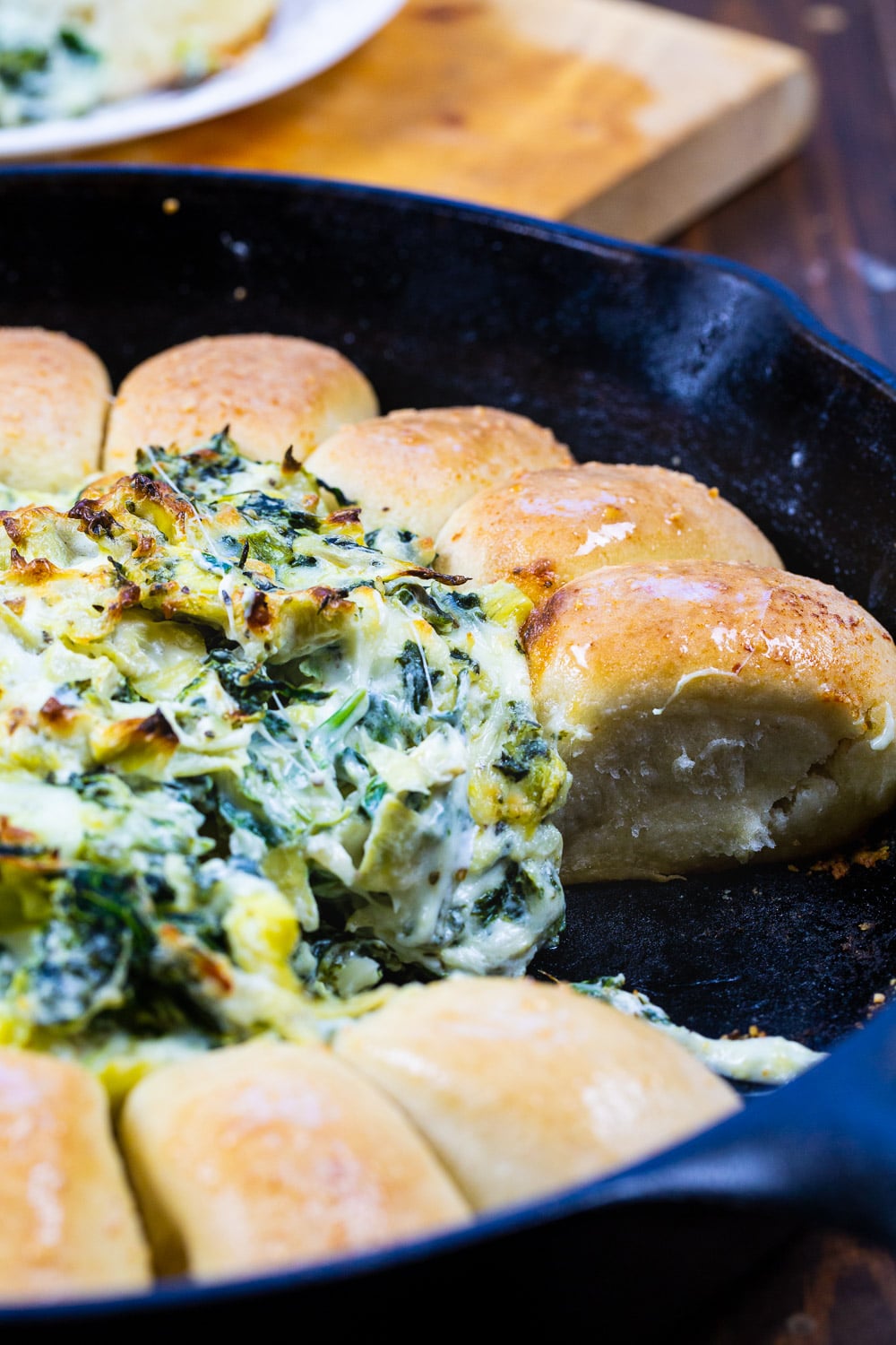Spinach Artichoke Dip Bread Ring with several rolls removed.