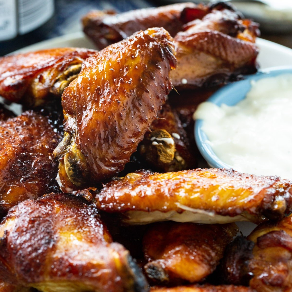 Sticky Soy Chicken Wings on a plate with dipping sauce.