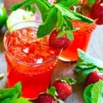 Two Strawberry Mojitos in glasses with mint.
