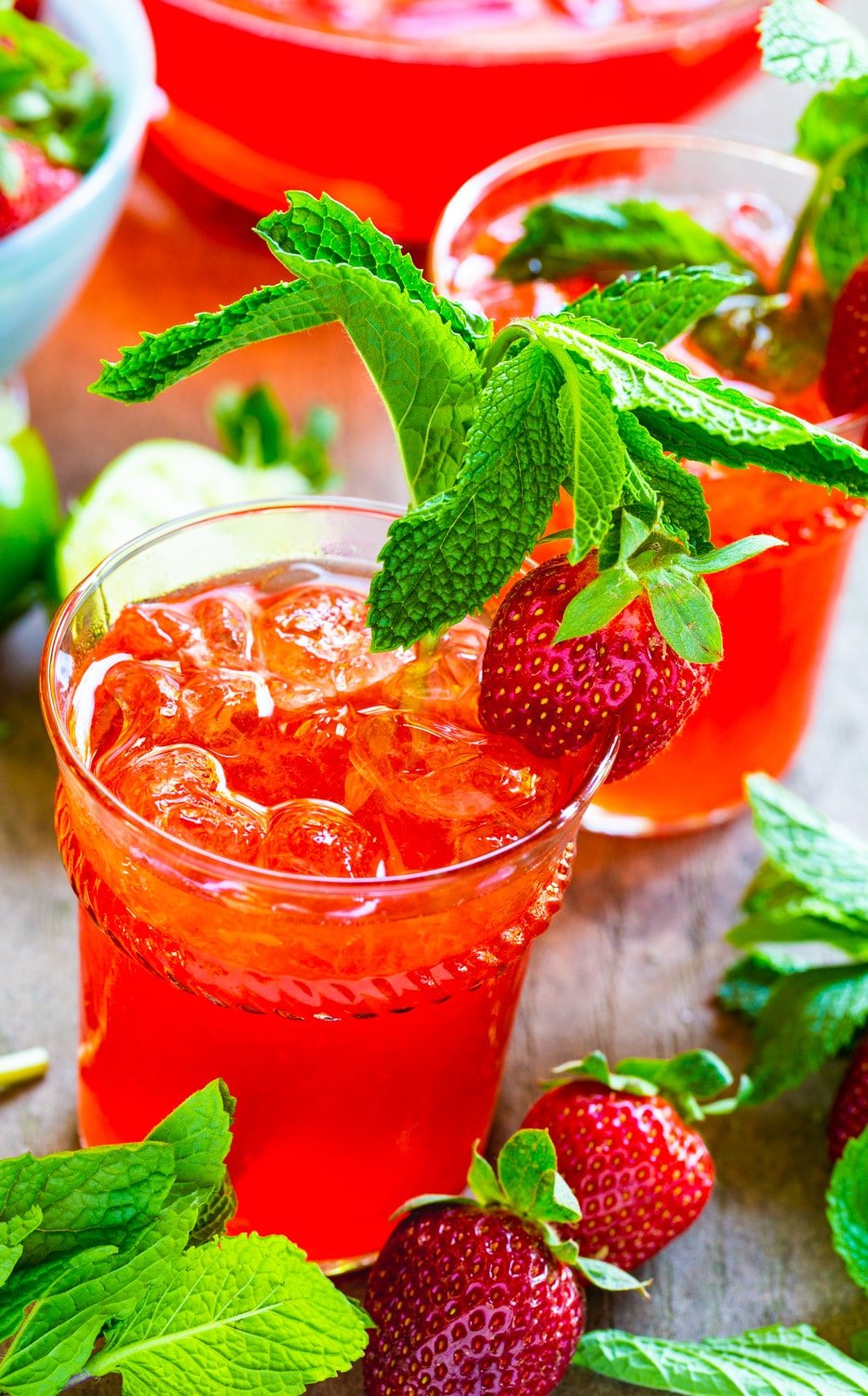 Strawberry Mojito in glass with lots of fresh mint and a fresh strawberry.