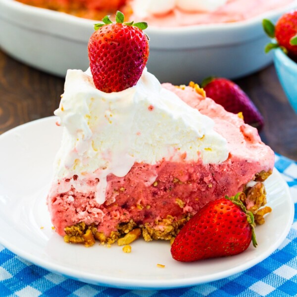 Slice of Strawberry Pretzel Icebox Pie on small white plate.