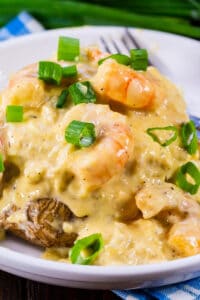 Double Stuffed Potatoes with Cheesy Seafood Sauce on a plate.