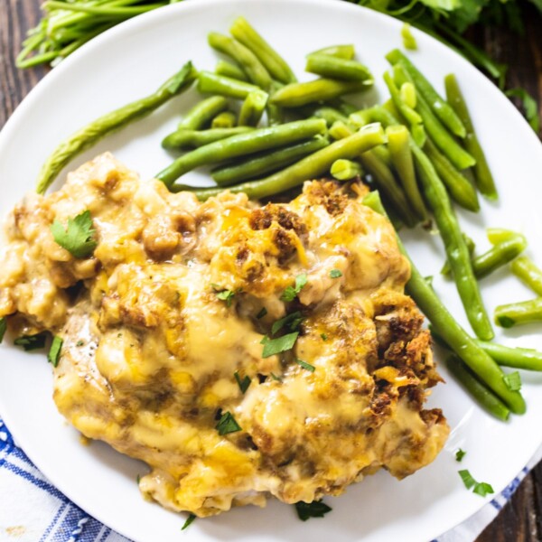 Stuffing Topped Pork Chop on a plate with green beans.