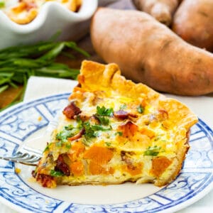 Slice of Roasted Sweet Potato Quiche on a plate.