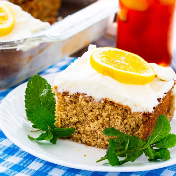 Slice of Sweet Tea and Lemonade Cake on a plate with fresh mint.