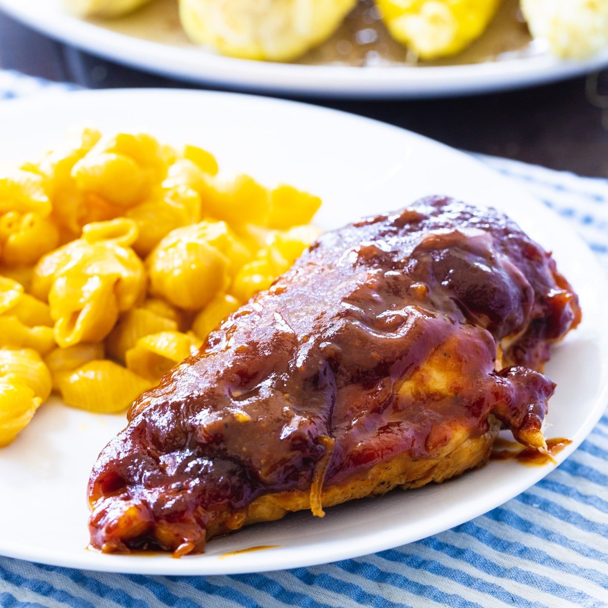 Sweet and Tangy Oven-Barbecued Chicken on a plate with mac and cheese.