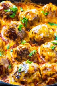 Tex Mex Meatballs coated with cheese in skillet.