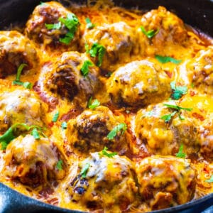 Tex Mex Meatballs coated with cheese in skillet.