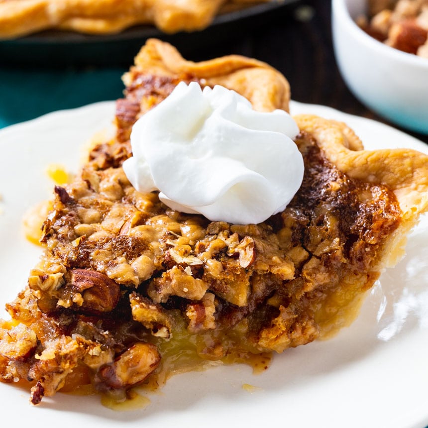 Toffee Nut Pie slice topped with whipped cream.