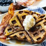 Waffled French Toast on a plate with bacon
