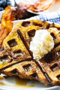 Waffled French Toast on a plate with bacon.