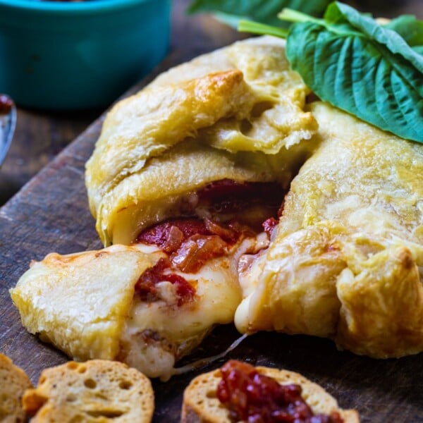 Wrapped Brie with Tomato Chutney with a slice pulled out.