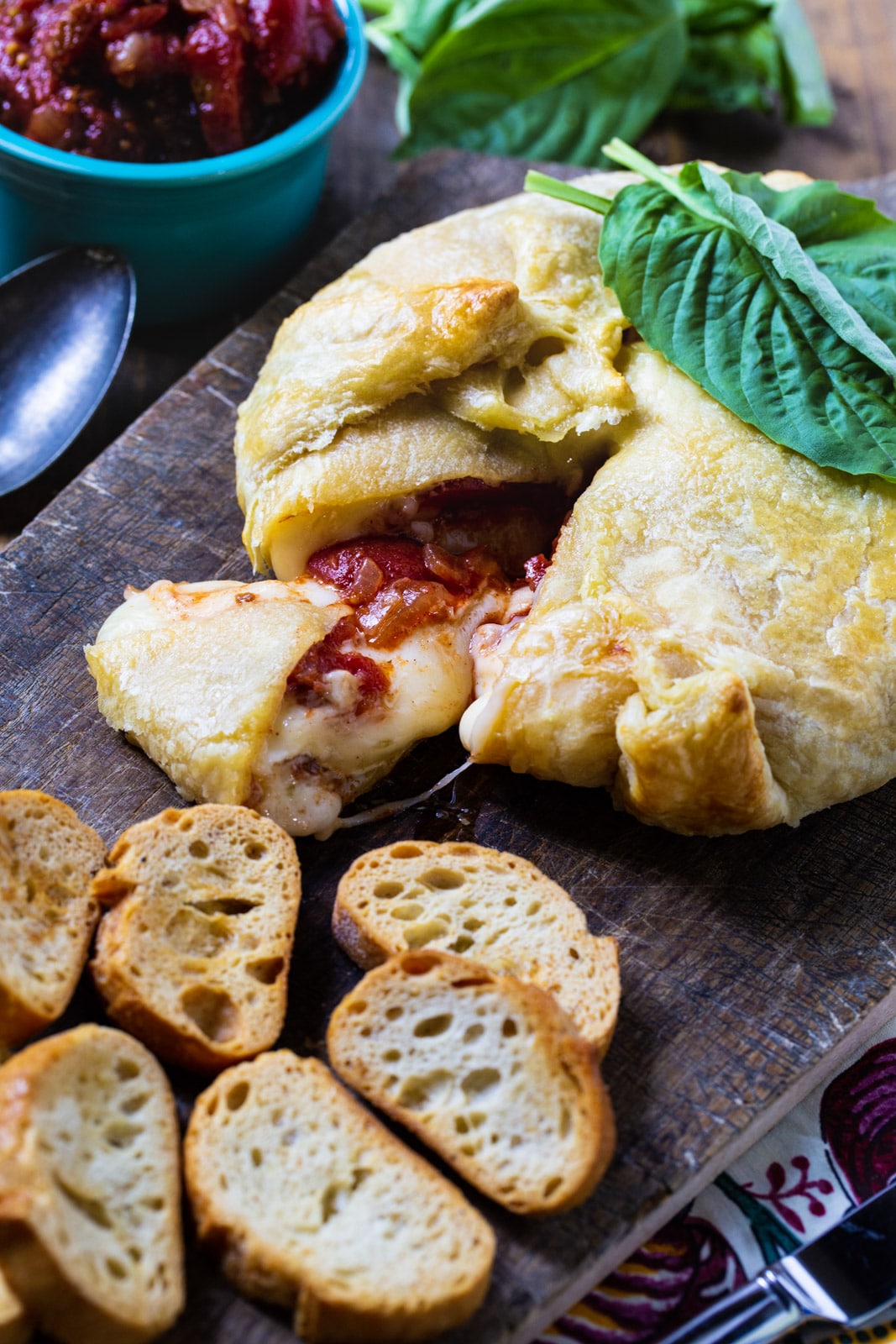 Wrapped Brie with Tomato Chutney with baquette slices.