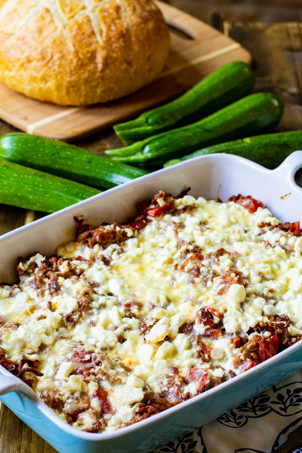 Zucchini Moussaka with a loaf of bread.