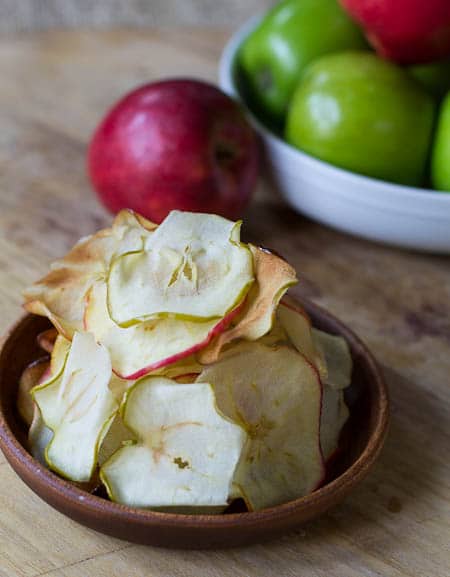 Caramelized Apple Chips on a small wooden plate.
