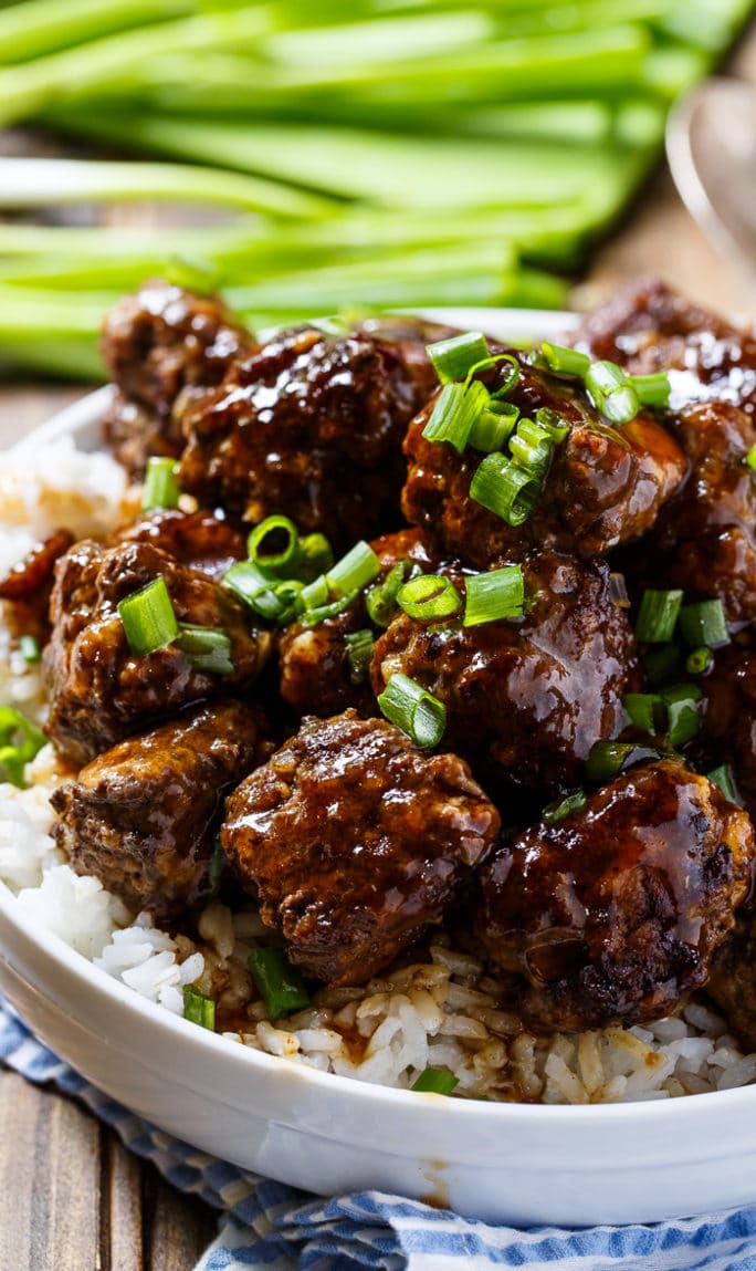 Spicy Apple-Glazed Meatballs served over rice in a bowl.