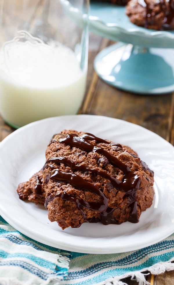 Two Chocolate Applesauce Scones on a plate with bottle of milk.