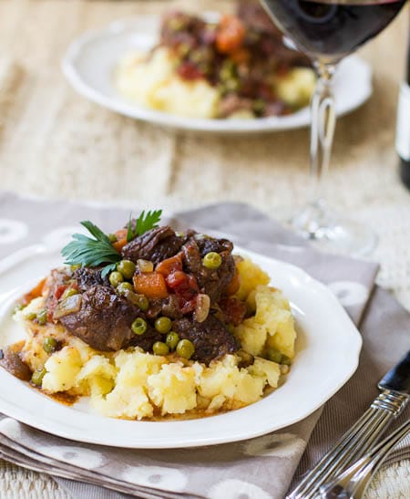 Beef Daube over mashed potatoes with a glass of red wine.
