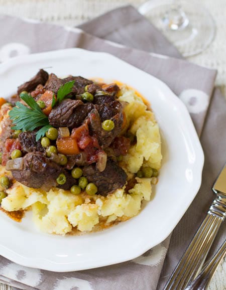 Beef Daube Provencal on a plate over mashed potatoes.