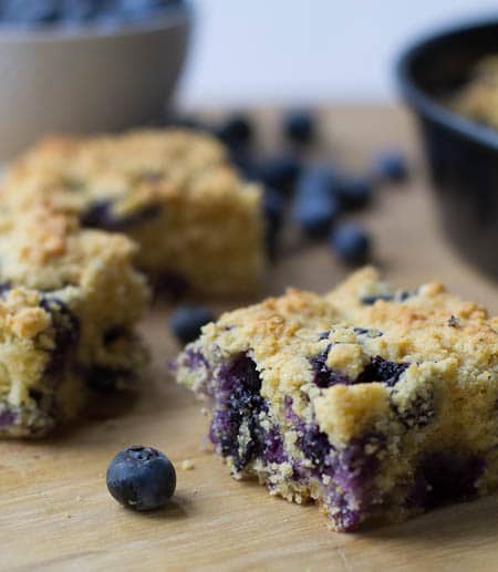 Cornbread with blueberries cut into squares.