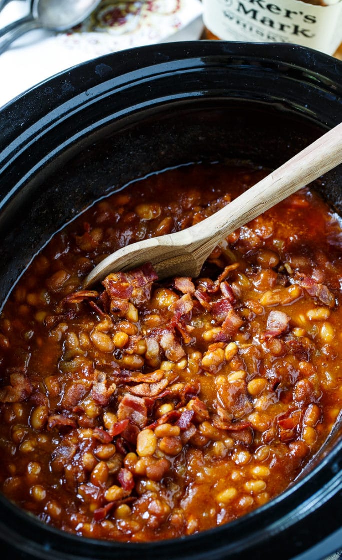 Slow Cooker Bourbon Baked Beans in a black slow cooker.