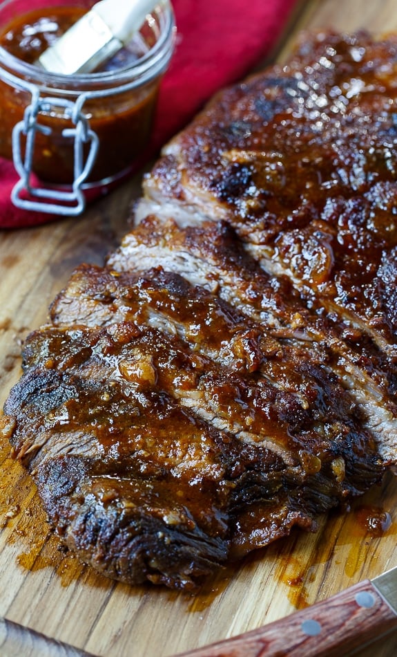 Oven-Barbecued Beef Brisket recipe from Cook's Illustrated. The best brisket cooked in the oven you will ever taste. Wrapped in bacon for smokiness and slow cooked. A few minutes under the broiler gives the outside a nice char.