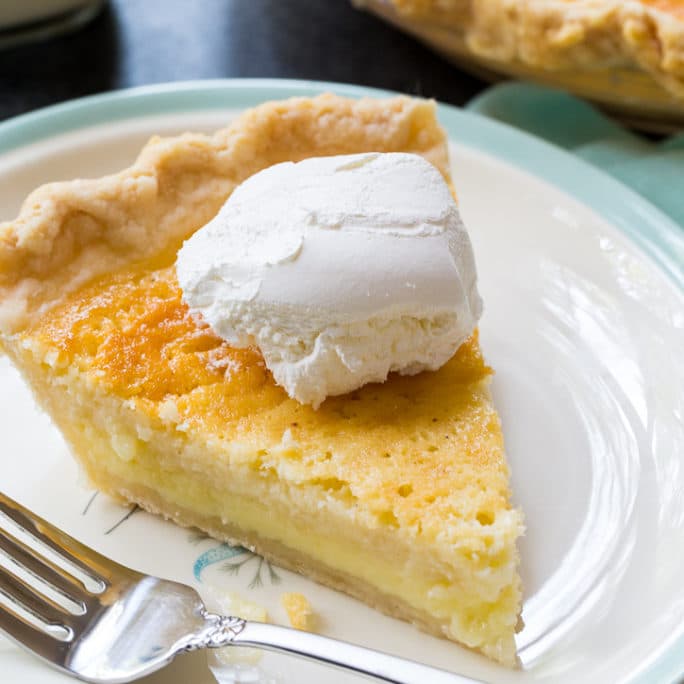 Old-fashioned Buttermilk Pie slice on a white plate.