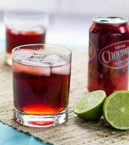 Cheerwine Cocktail with lime halves.