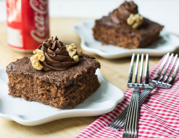 Two pieces of Coca Cola Cake with forks.