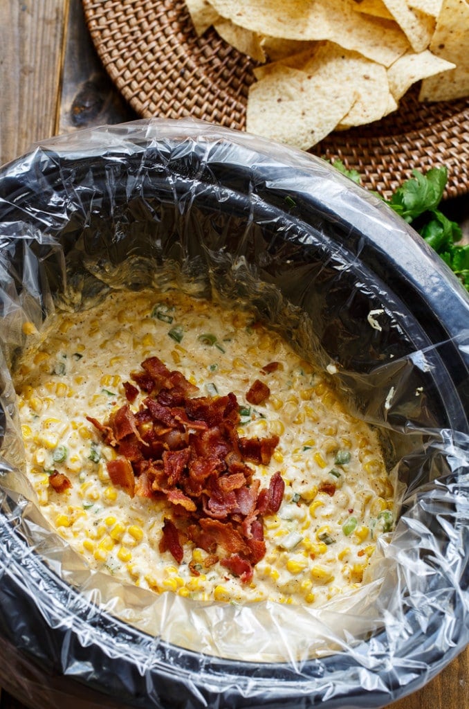 Slow Cooker Corn Salsa with easy clean-up thanks to Reymolds Slow Cooker Liners. Dump everything in the crock pot and 2 hours later you have a warm and creamy dip.